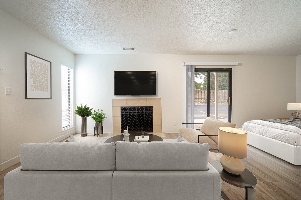 a living room with a couch and a tv above a fireplace